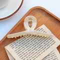 Elegant cream acetate hair claw clip with marble texture and cross ribbon design - Shimmering Beige White