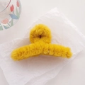 Fuzzy yellow faux fur hair claw clip for women's winter hairstyling on a white paper - Yellow