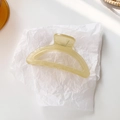 Translucent beige crescent hair claw clip with silver spring on white background - Light Yellow