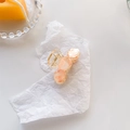 Elegant peach acetate hair claw with gold flakes and a geometric triple circle design - Three-Round Piece (C779) / Orange