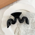 Pinza de pelo negra brillante con diseño ondulado en un plato decorativo vintage - Negro