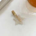 Star-shaped hair clip with white pearlescent marble texture on a gold metal alligator clip - Iridescent With Gold Clip