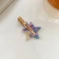 Star-shaped acetate hair clip with purple and blue marble pattern on a gold duckbill clip - Purple With Gold Clip