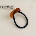 Minimalist hair tie featuring an amber tortoiseshell resin ring with a high-elastic black band - Amber Semicircle Style