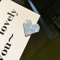 Blue and white checkered marble heart hair clip with pixelated edges on a card - Blue White Marble