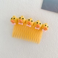 Yellow kids hair comb featuring five cartoon ducks with pink bows for girls - Little Duck