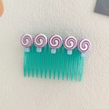 Girl's hair comb with five purple lollipop decorations and a blue comb base - Lollipop Style