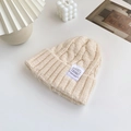 Chic cream-white cable knit beanie for women featuring a minimalist decorative brand patch - Apricot