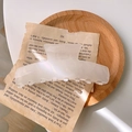 Pearlescent creamy white acetate hair claw clip with a glossy finish on a wooden tray - White