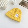 Lemon yellow cable knit beanie for women with a stylish white text patch label - Yellow