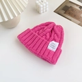 Thick rose pink cable knit beanie with decorative white woven patch and stylish fold-over cuff - Rose Red