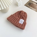 Thick cable knit beanie in warm caramel brown with a white woven square logo label - Caramel color