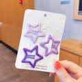 Set di tre fermagli per capelli a stella viola opaco per bambine su carta bianca - Stile Stella