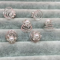 Detailed macro view of six-petal flower hair pins with pearls and sparkling rhinestones - Six-Petal Flower White