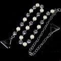 Close-up of adjustable silver lingerie straps with white pearls and sparkling rhinestones - Pearl Style