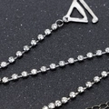 Detailed macro view of silver rhinestone chain with round claw-set crystals and metal hook - Black Base Silver Rhinestone