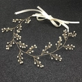Detail showing pearl vine headband with golden wire branch structure and white satin ribbon - Gold