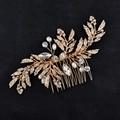 Elegant gold leaf bridal hair comb with crystals and pearls on black leather background - Pave Set Hair Comb