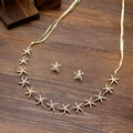 Golden starfish necklace and earrings set with micro-pave crystals on wood background - Gold Starfish Headband And Earrings Set