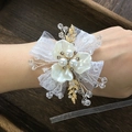 Elegant white floral wrist corsage with pearls, gold leaves and lace ribbon detail - White Wrist Flower