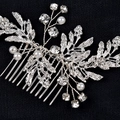 Macro shot of bridal hair comb with silver leaves, white pearls and sparkling rhinestones - Prong Set Hair Comb