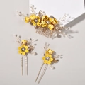 Close-up of three-piece yellow floral hair comb and pin set with pearls and gold leaves - Yellow