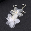 Detailed view of handmade white organza flower hairclip with pearls and gold wire accents - White Corsage