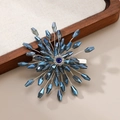 Detail of blue crystal bridal hair clip with silver wire radiating floral pattern - Teal