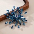 Detailed view of handmade blue crystal flower hair clip with central gemstone and silver base - Sapphire Blue