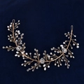 Handmade bridal headband with white pearls and crystals on gold wire against blue velvet - Gold