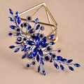Close-up of golden leaf hair accessory with dark blue marquise crystals on warm sand background - Royal Blue Single