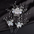 Elegantes Braut Haarschmuck Set mit schillernden Blüten auf schwarzem Satin - Irisierendes Blumen-Set