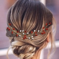 Detail of bridal hair vine with red rhinestones and white pearls on golden wire - Red