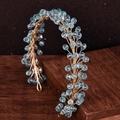 Detailed macro view of golden wire hair vine with faceted light blue crystal beads - Light Blue Crystal