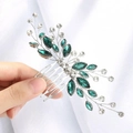 Detailed shot of handmade bridal hair comb with green rhinestones and silver metal branches - Green