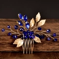 Detail of emerald green crystals and golden metal leaves on a bridal hair comb - Royal Blue