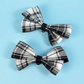 Set of two black and white plaid bow shoe clips with metal attachment on blue backdrop - Bow / Black And White Plaid