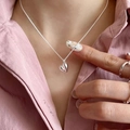 Polished S925 sterling silver 3D heart pendant necklace worn on pink fabric background - Silver