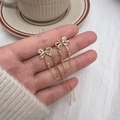 Pendientes de lazo dorado con borlas de corazón de circonita y cadena elegante - Cobre / Dorado
