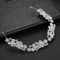 Exquisite silver bridal headband with crystal floral design on black background - Silver
