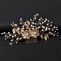 Detailed close-up of golden bridal hair comb with pearls and rhinestones flower design - Bright Gold