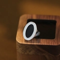 Minimalist silver oval signet ring with black enamel inlay on natural wood display - Adjustable Open / Silver