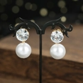 Elegant bridal zircon drop earrings with large round pearls on vintage display stand - Gold Earrings