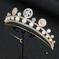 Close-up of luxury gold bridal tiara with pearls and crystals on a black stand - Gold Tiara