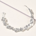 Close-up of silver bridal headband with intricate alloy flowers and sparkling rhinestones - Silver