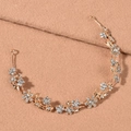 Close-up of golden bridal headband featuring alloy flowers and crystal leaf design details - Gold