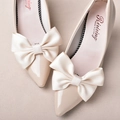 Elegant bridal beige pointed-toe heels with large satin bow accents for wedding decoration - Off White