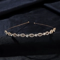 Macro-opname van bruid hoofdband met fonkelende strass-steentjes op donkere textuur stof - Goud