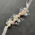 Detail showing handmade bridal pearl hairband with frosted flower petals and silk ribbon - Bracelet (Short) / Pink
