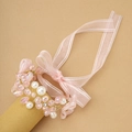 Elegant bridal wrist corsage with pink crystals, white pearls, and gold wire for weddings - Rose Quartz